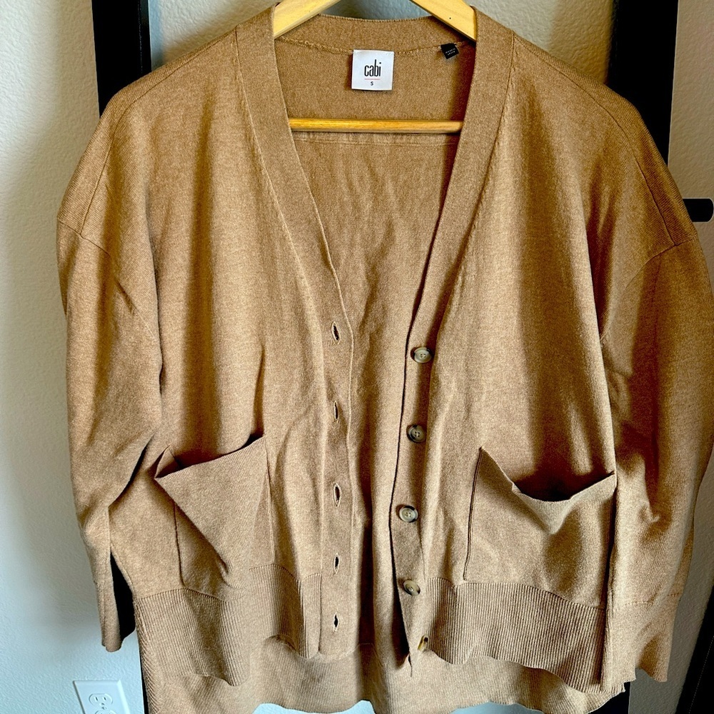 Nice tan sweater. Longer in the back than front. Great condition.